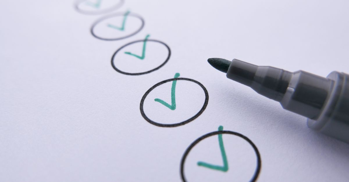 A line of hand-drawn circles on white paper, each marked with a green check, the tip of a black marker at the last one.